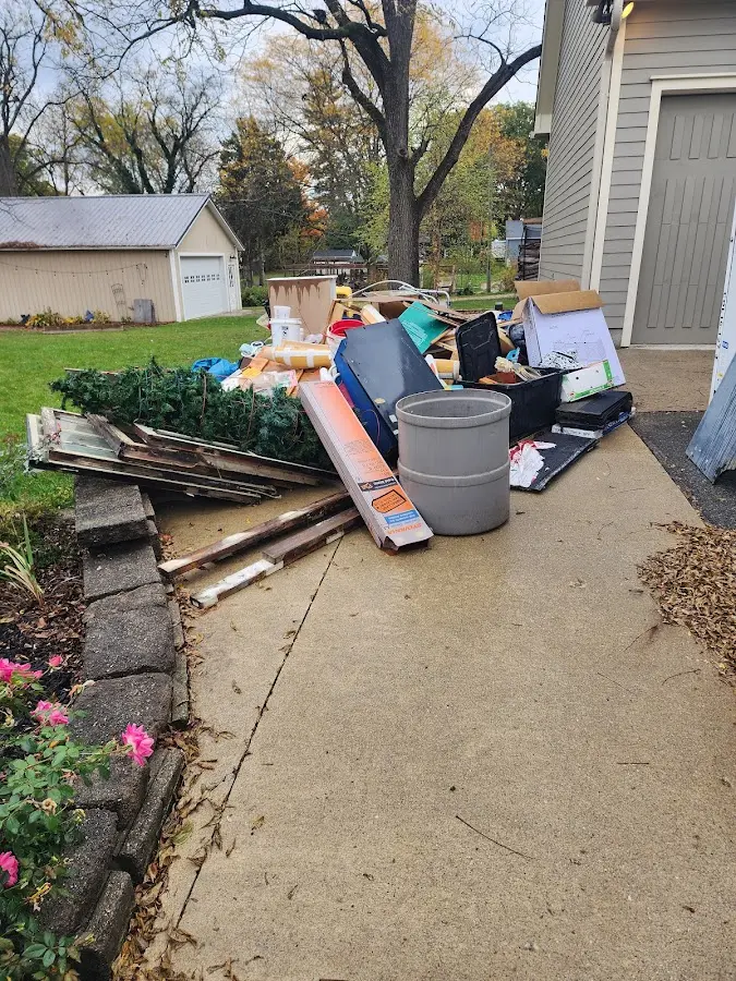 Dumpster being loaded with debris for Estate Cleanout Dumpster Rental in Hastings